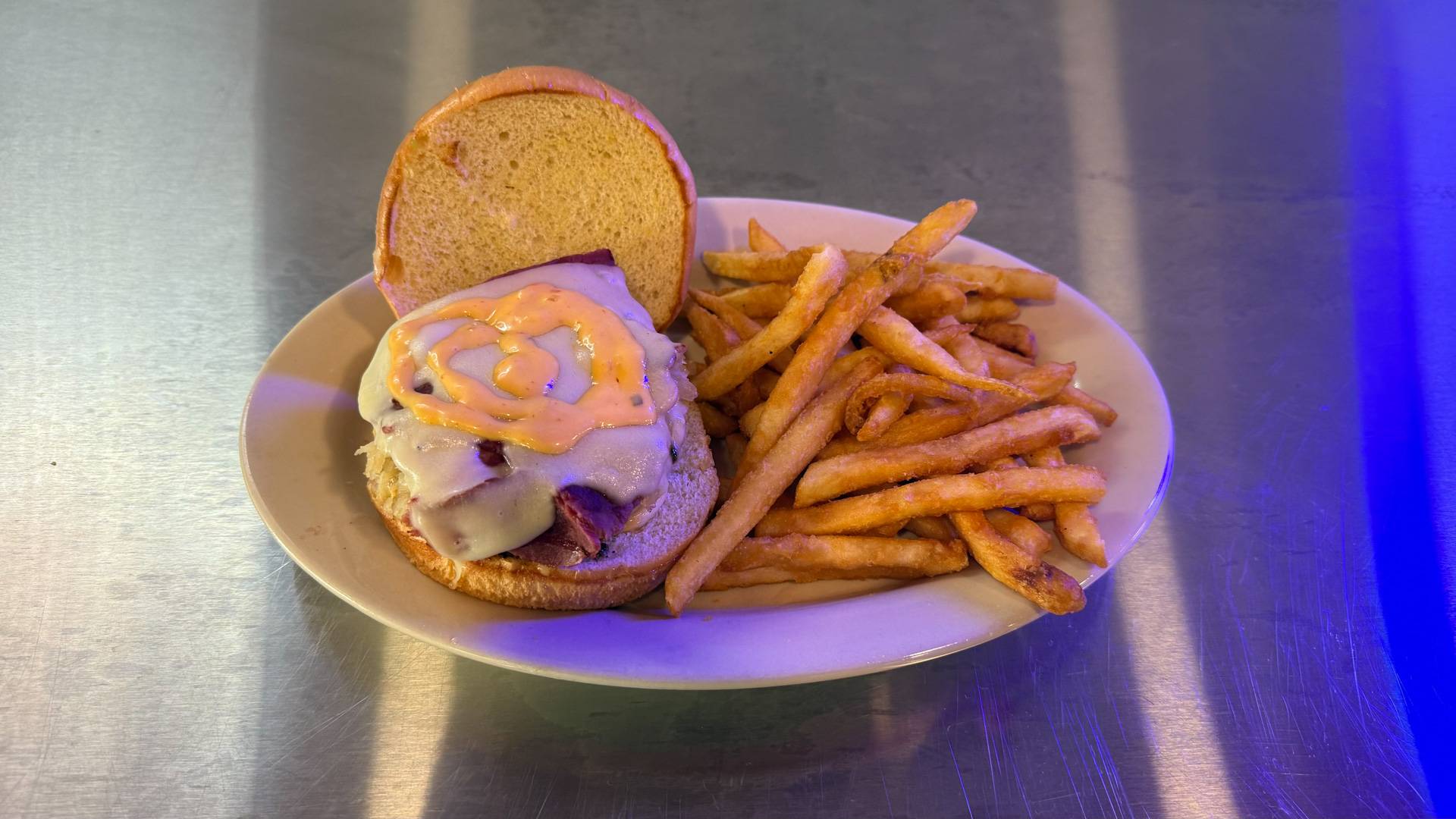 Reuben Burger at Brooks Burgers in Naples, Florida, featuring a juicy beef patty with corned beef, Swiss cheese, sauerkraut, and Russian dressing