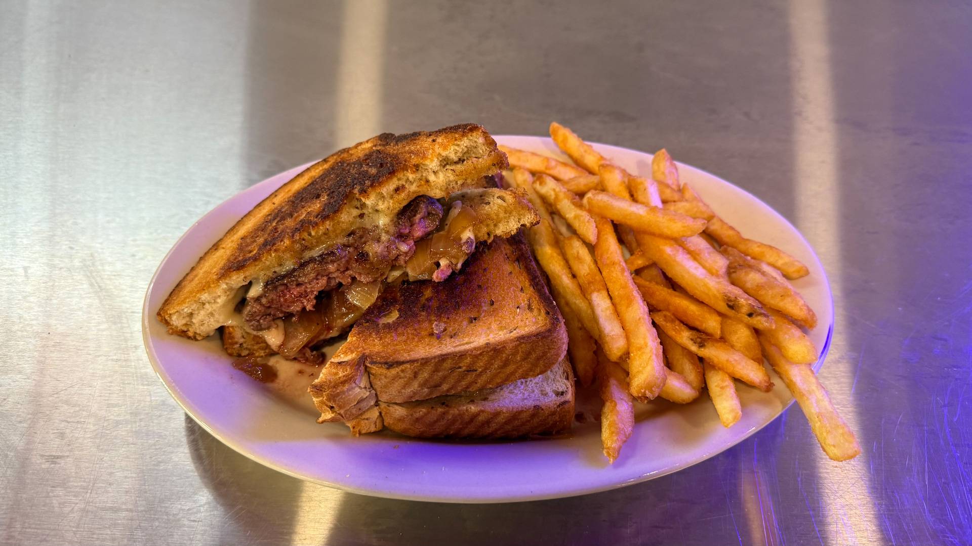 Delicious patty melt served at Brooks Burgers in Naples, Florida, featuring toasted rye bread, juicy beef patty, melted Swiss cheese, and caramelized onions.