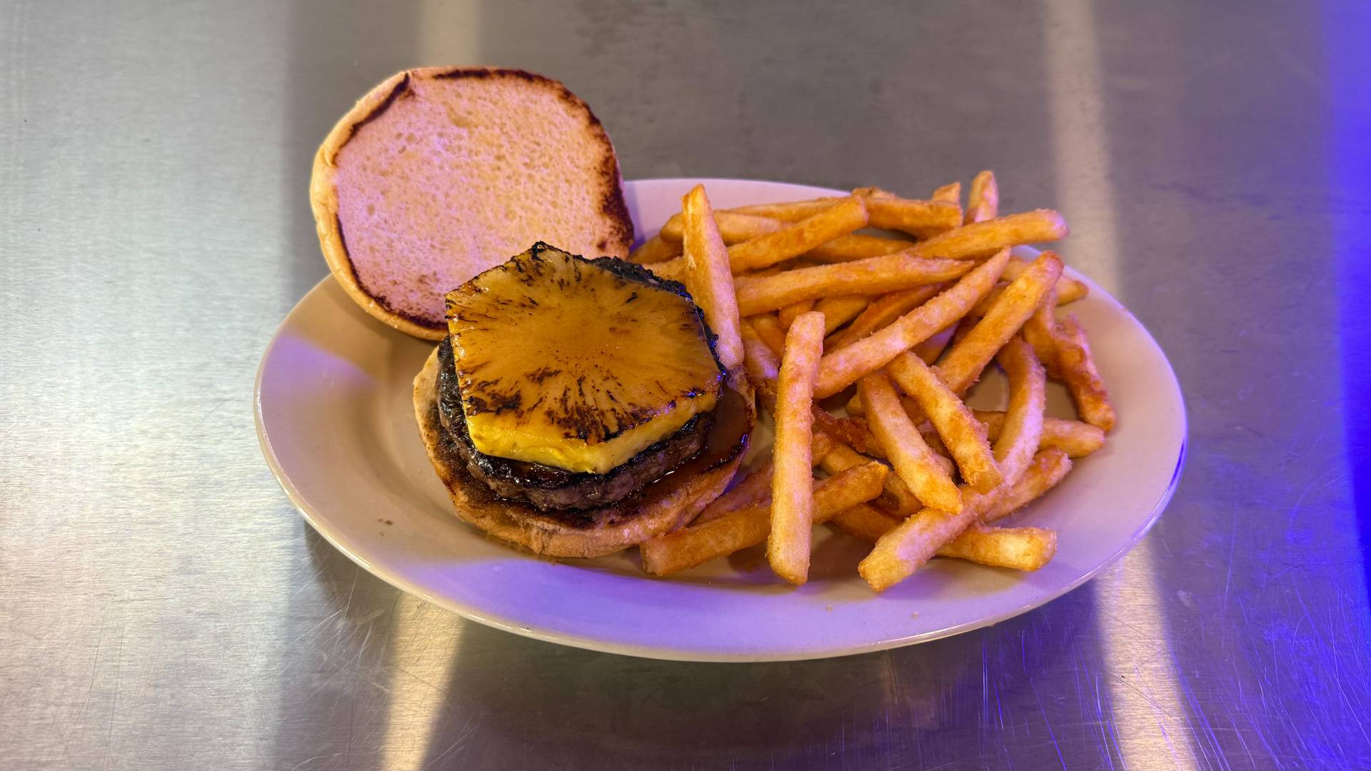 A mouth-watering handcrafted burger with cheese, lettuce, and tomato at Brooks Burgers in Naples